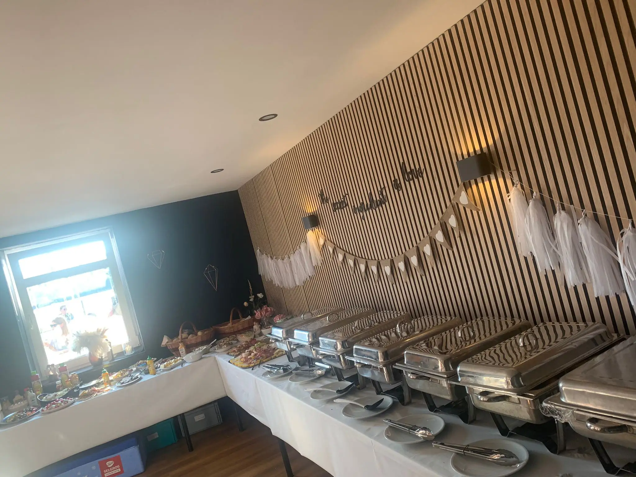 Warmhaltebehälter, Teller und Besteck auf dem Buffettisch
